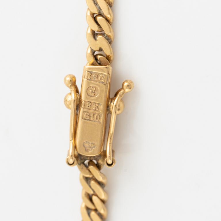 Gold and brilliant cut diamond bird necklace.