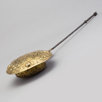 An 18th century brass bed warmer.