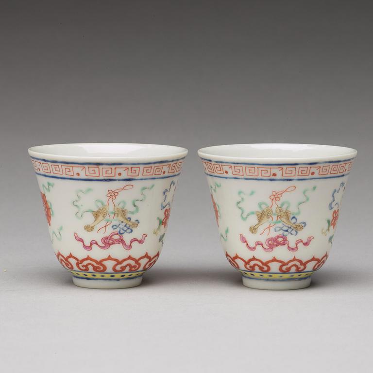 A pair of Chinese famille rose ba jixiang wine cups, Republic, with Guangxu six character mark.
