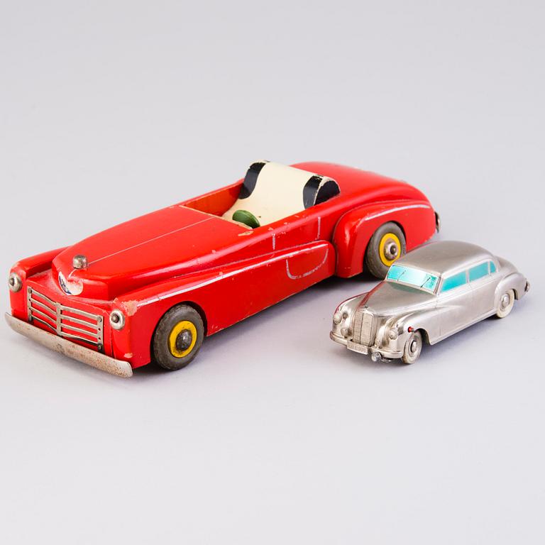 Two mid-20th century toy cars, chromed metal and wood.
