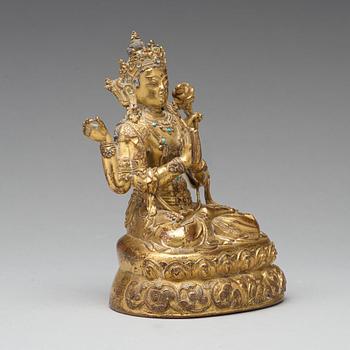 A gilt copper alloy four armed Sadaksari Avalokiteshvara, Tibet/Nepal, 15th Century or older.