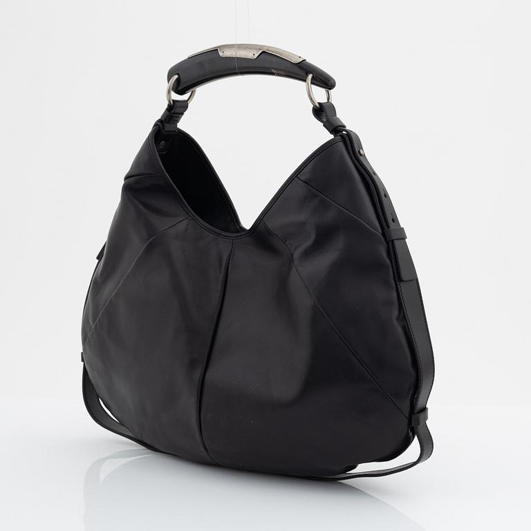 Yves Saint Laurent, a black leather and horn hobo bag.