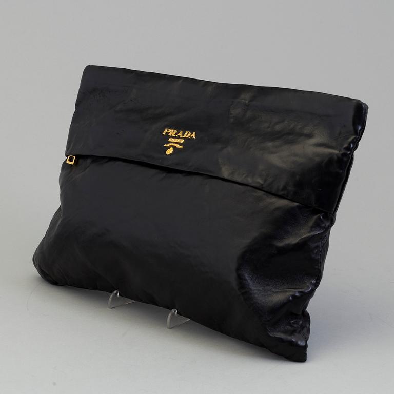 A black leather bag/clutch by Prada.