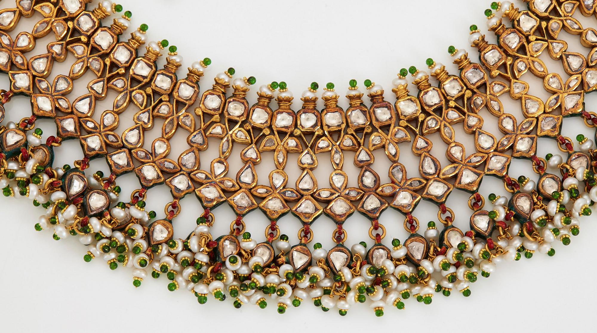 An Indian demi parure comprising a necklace and a pair of earrings.