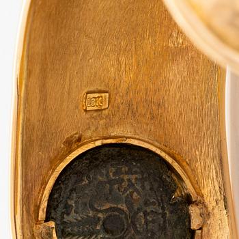 An 18K gold bangle set with an ancient coin.