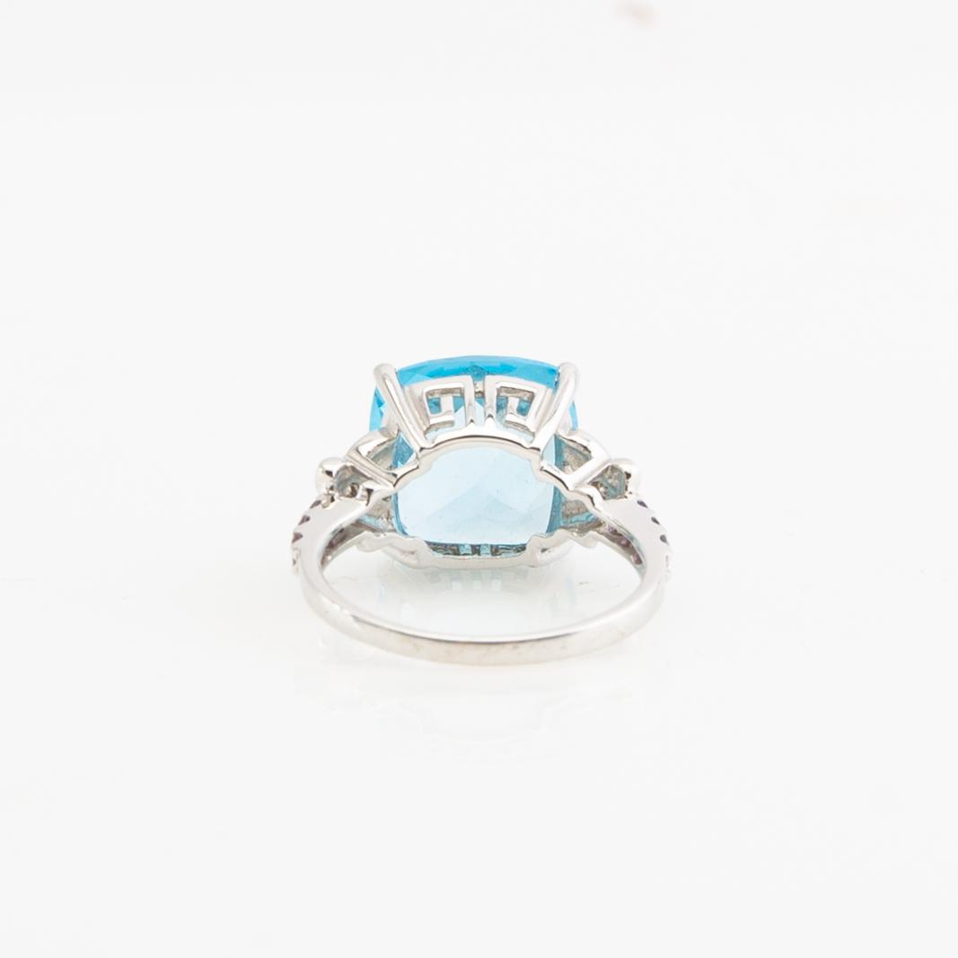 Ring, 14K gold with topaz, diamonds, and purple garnets.