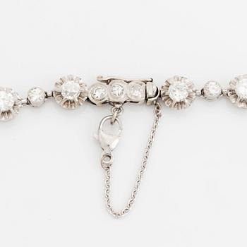 A platinum necklace set with old-cut diamonds.