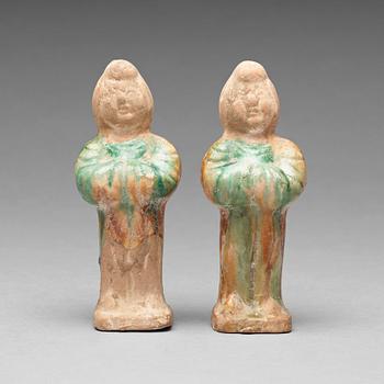 129. Two green and yellow glazed pottery figures of female attendants, Ming dynasty (1368-1644).