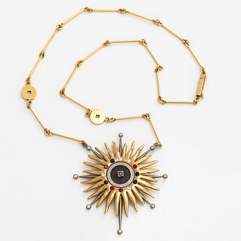 Pendant, faceted sapphires, rubies and diamonds, iron ore, 18K gold and white gold.