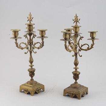 A mantle clock with pair of candelabra, late 19th century.