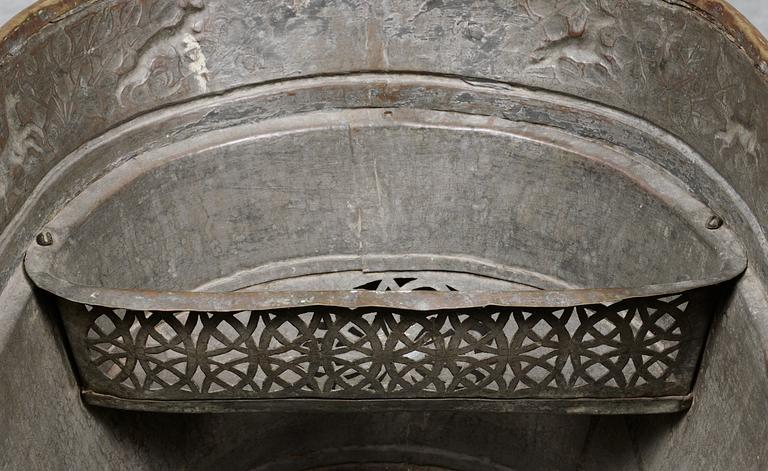 A Baroque brass wine cooler.