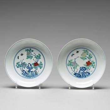 606. A pair of 'butterfly and peonies' dishes, Qing dynasty with Yongzheng mark.