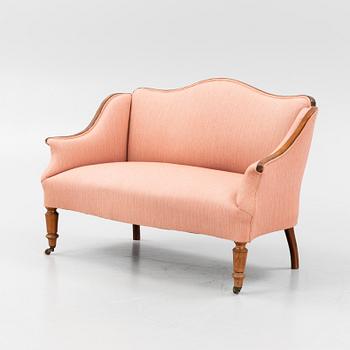 A stained beech sofa, late 19th Century.
