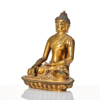 A gilt copper alloy figure of buddha, Nepal, 18th Century.