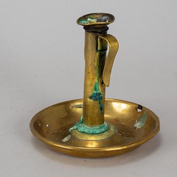 A 19th century brass night light holder.