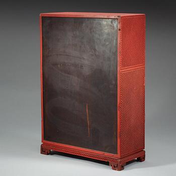 A well carved cinnaber lacquer 'Kang' cabinet, Qing dynasty, 18th Century.