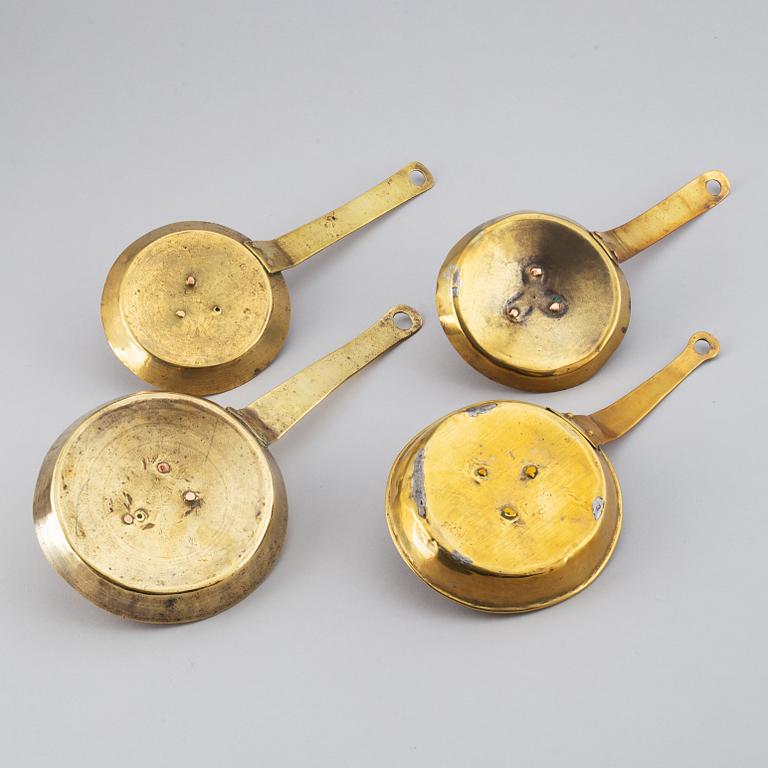 Four 18th century brass night light holders.