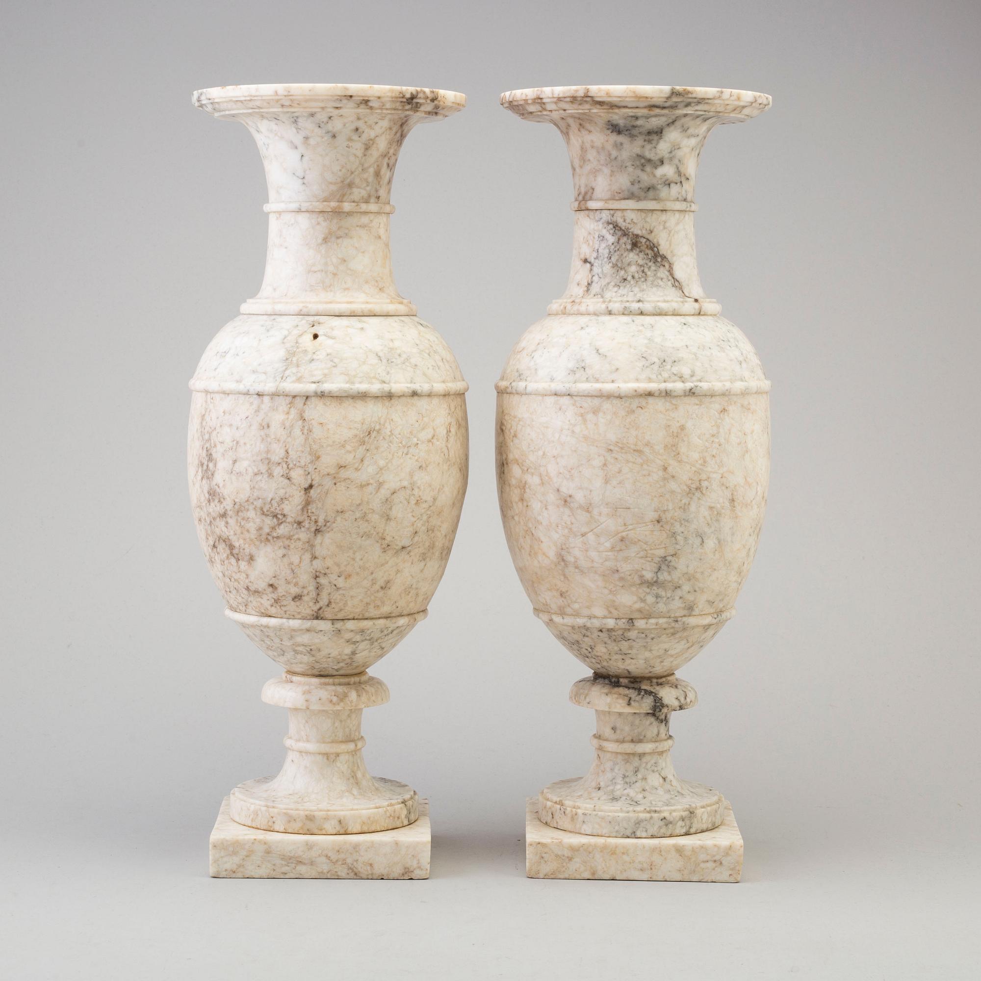 A pair of marble urns, circa 1900.