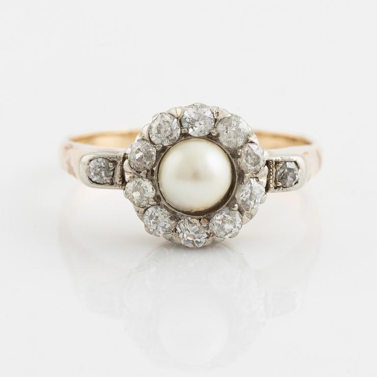 A 14K gold ring set with a pearl and old-cut diamonds.