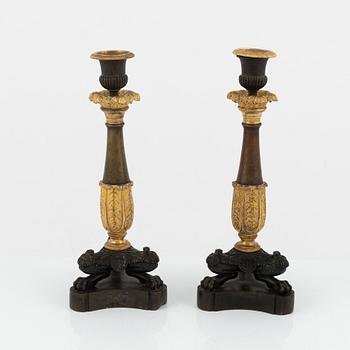 A pair of 19th century empire-style bronze candlesticks.