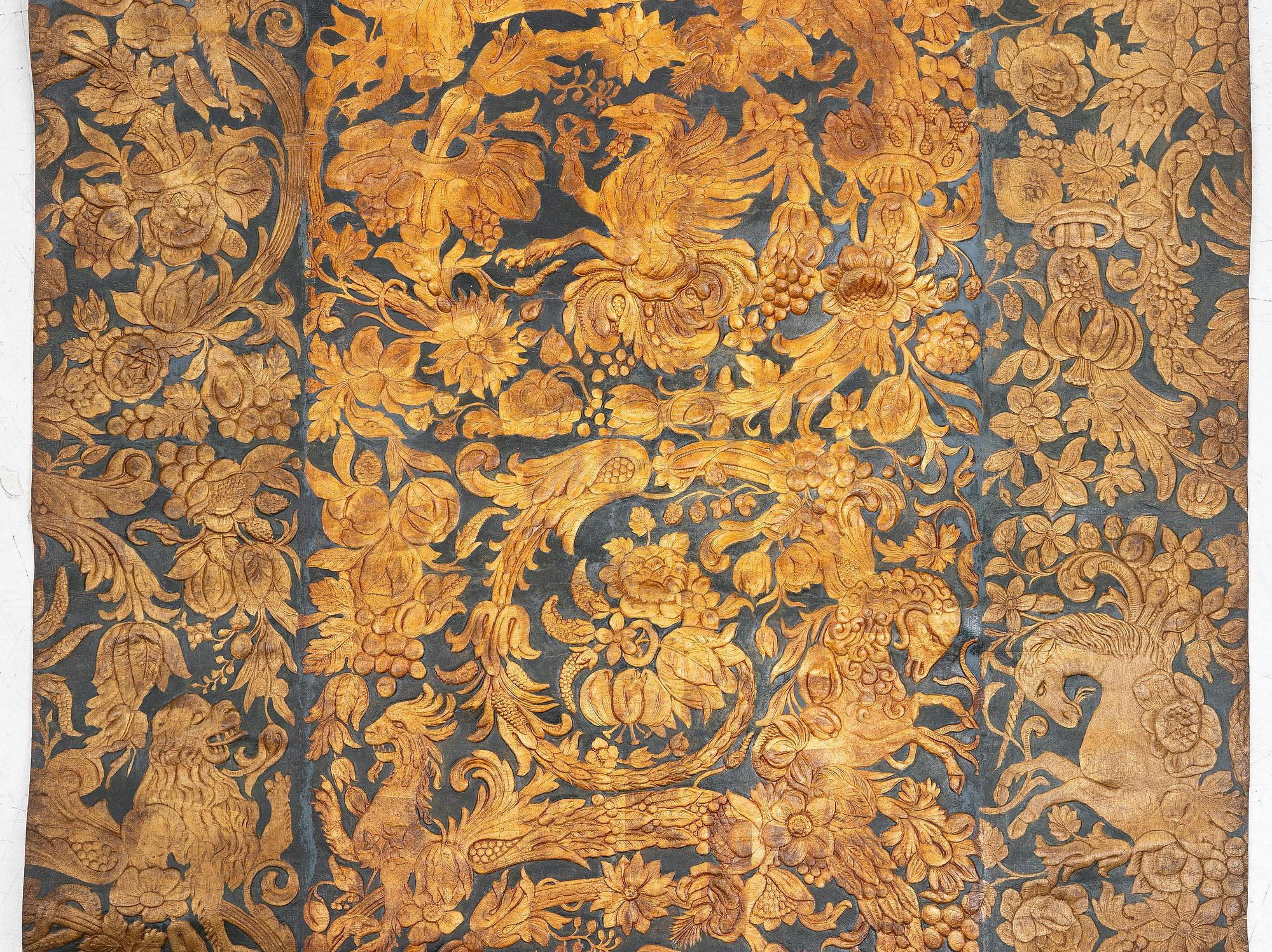 A 19th century wrought leather wallpaper, ca 388 x 97 cm.