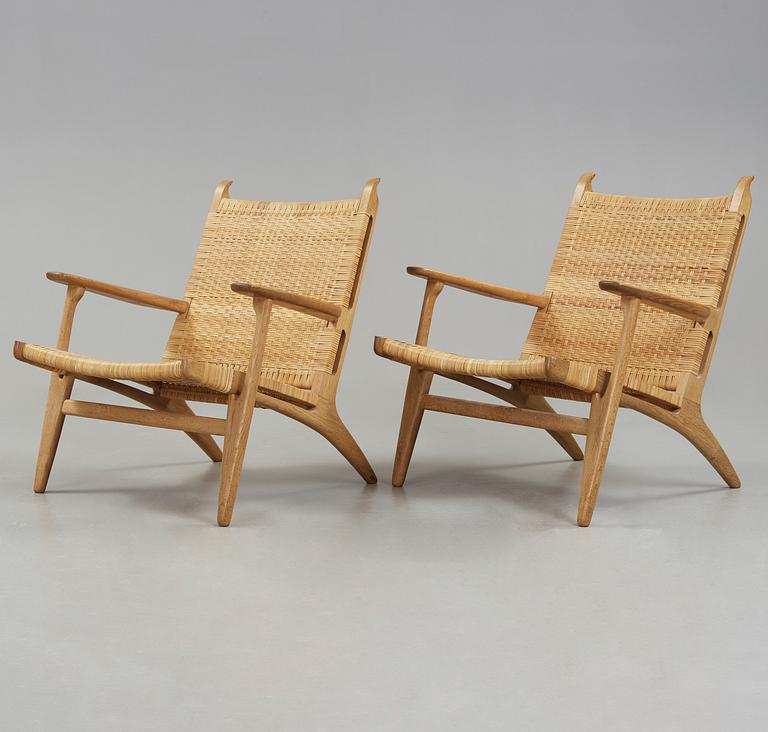 A pair of Hans J Wegner oak and rattan easy chairs 'CH-27', Carl Hansen & Son, Denmark.