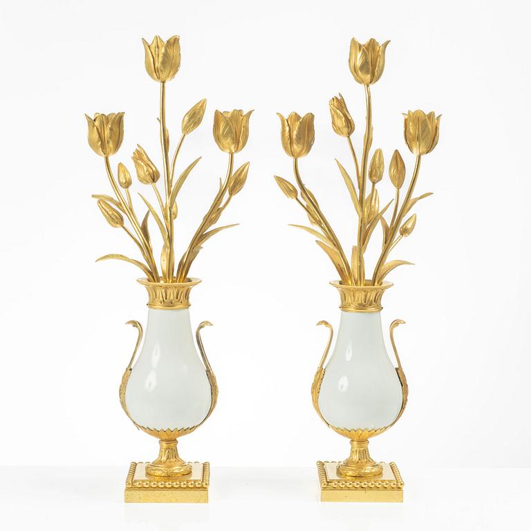 A pair of three light porcelain and gilt bronze three-branch Louis XV-style candelabra, mid 19th century.