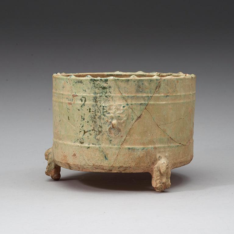 A green glazed tripod censer, Han dynasty (206 BC - 220 AD).