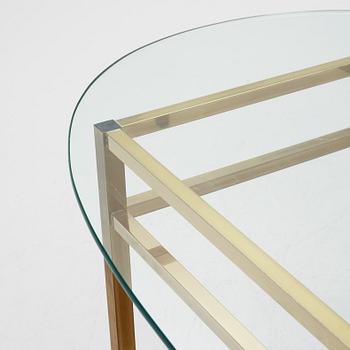 A 1970's glass and brass coffee table.