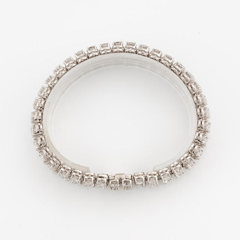 A platinum bracelet set with round brilliant-cut diamonds.