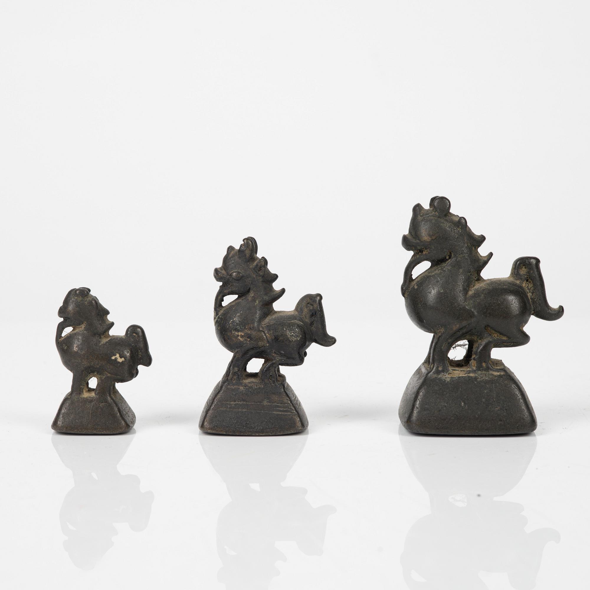 A Tibetian prayer wheel and three bronze opium weights, probably Burma.