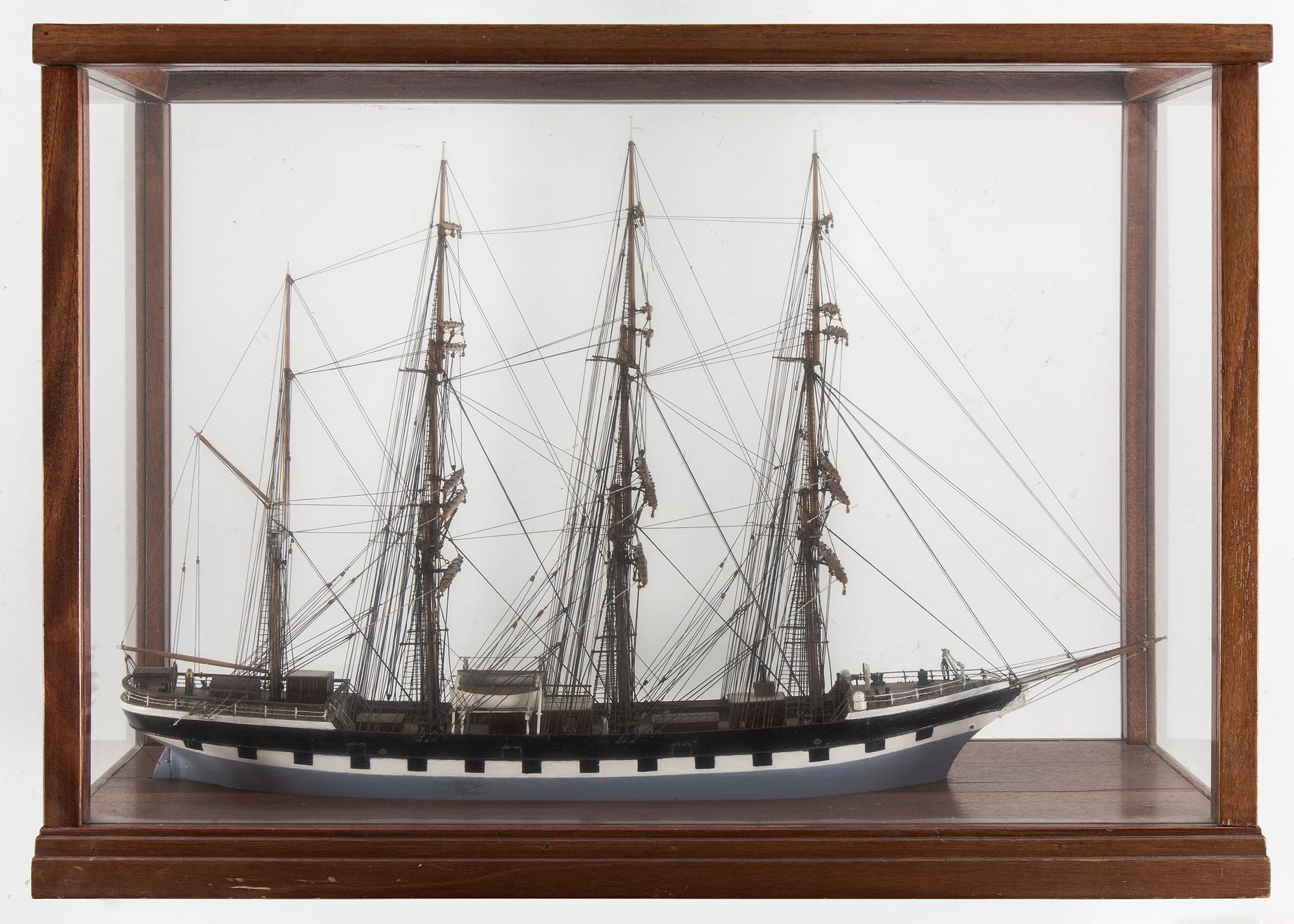 A model of a sailing ship with four masts in a glass and mahogany box by Gustav Sixten Wiman, 20th century.