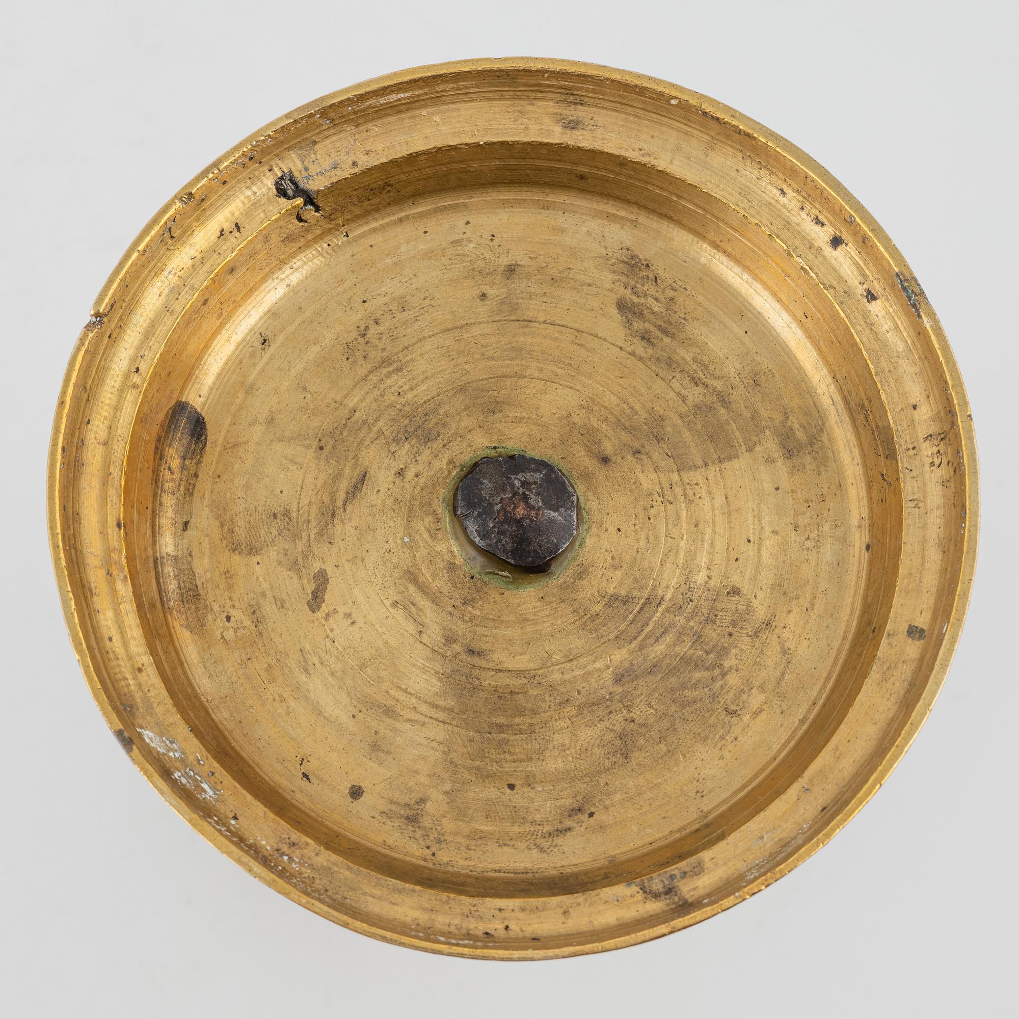 A brass candlestick, 18th century.