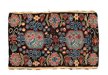 221. A carriage cushion, "Den innelykta fågeln"  tapestry weave, ca 54 x 87 cm, Scania, 1760, signed EMD.