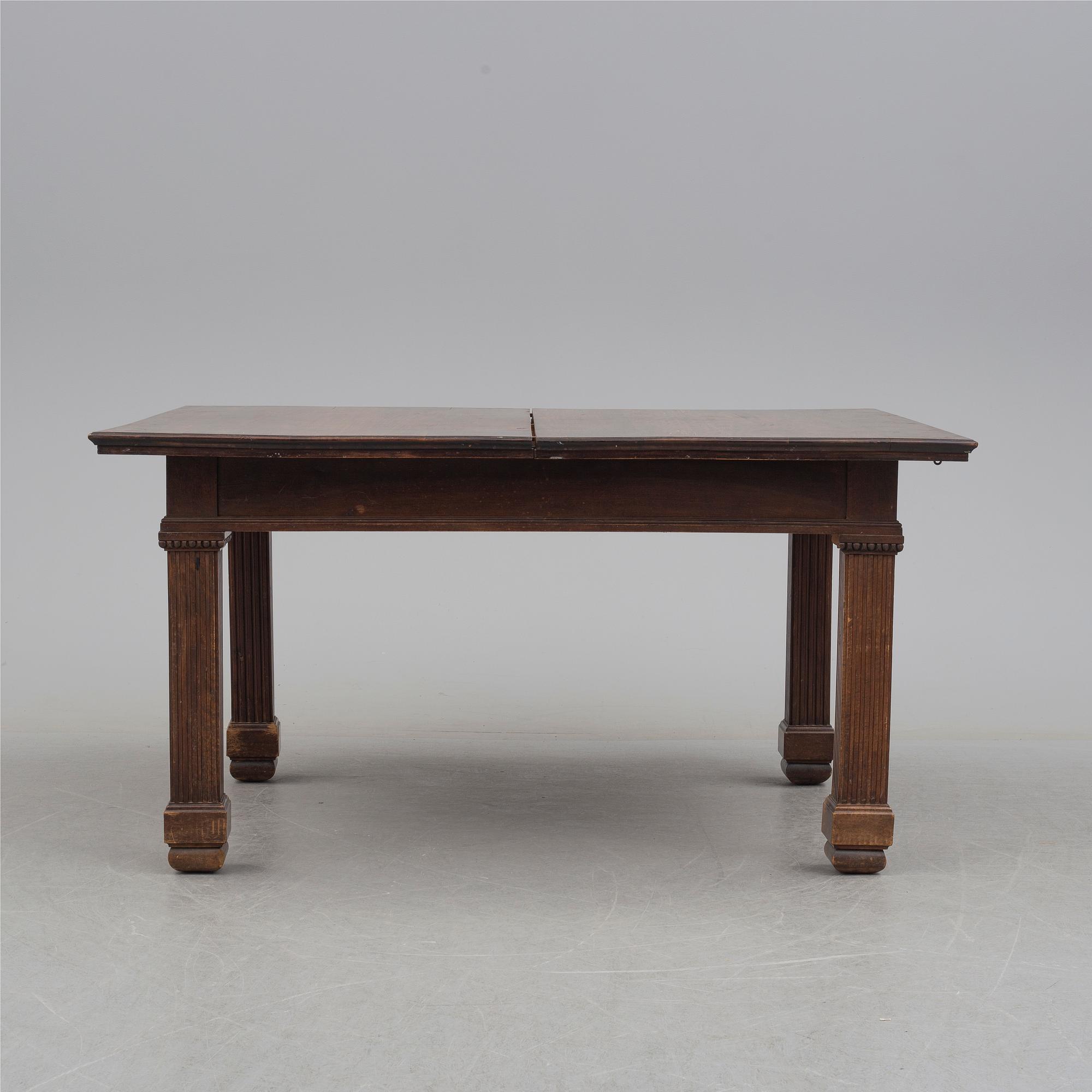 A 19th century dining table and a set of twelve chairs.