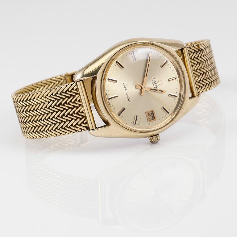 ARMBANDSUR, guld på stål, Omega Seamaster, armband i 18K guld, 1900-talets andra hälft. Total vikt ca 87 g.