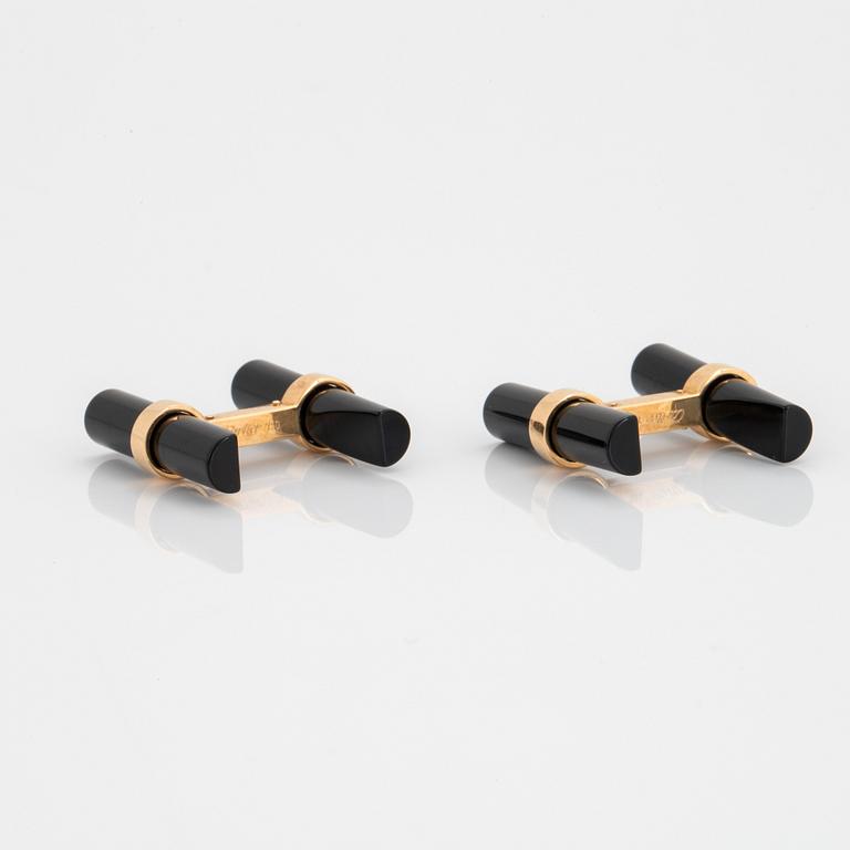 A pair of Cartier cufflinks in 18K gold and onyx.