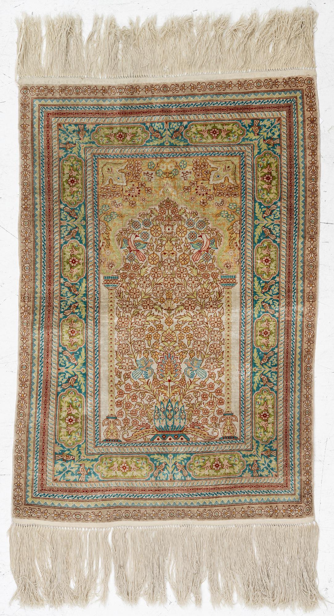 A semi-antique silk Hereke, c. 92 x 61 cm.