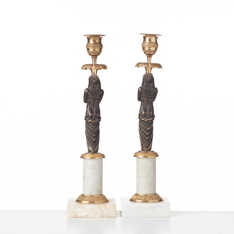 A pair of late Gustavian circa 1800 white marble and bronze candlesticks.