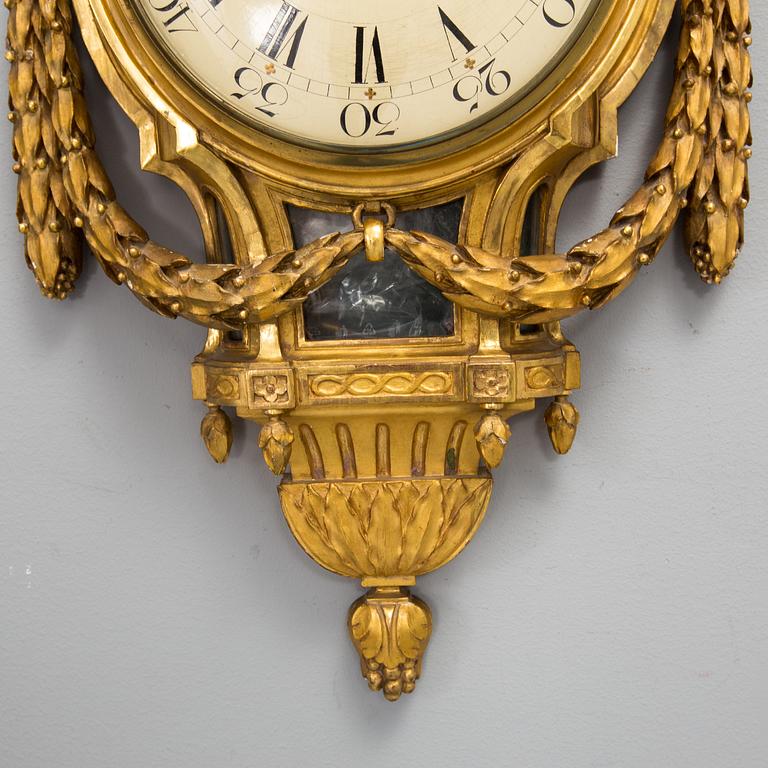 A wall clock in gustavian style, marked Rob. Engström, Stockholm.