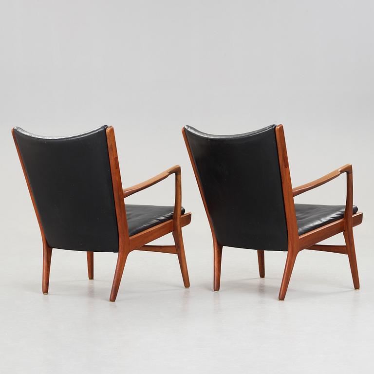 Hans J. Wegner, a pair of "AP16" teak and black leather armchairs, AP-stolen, Denmark 1950-60´s.