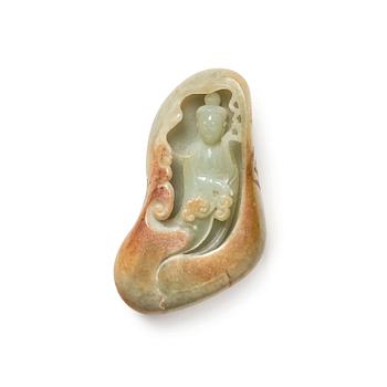 1022. A Chinese russet nephrite sculpture of a Guanyin, placed in a boalder, 20th Century.