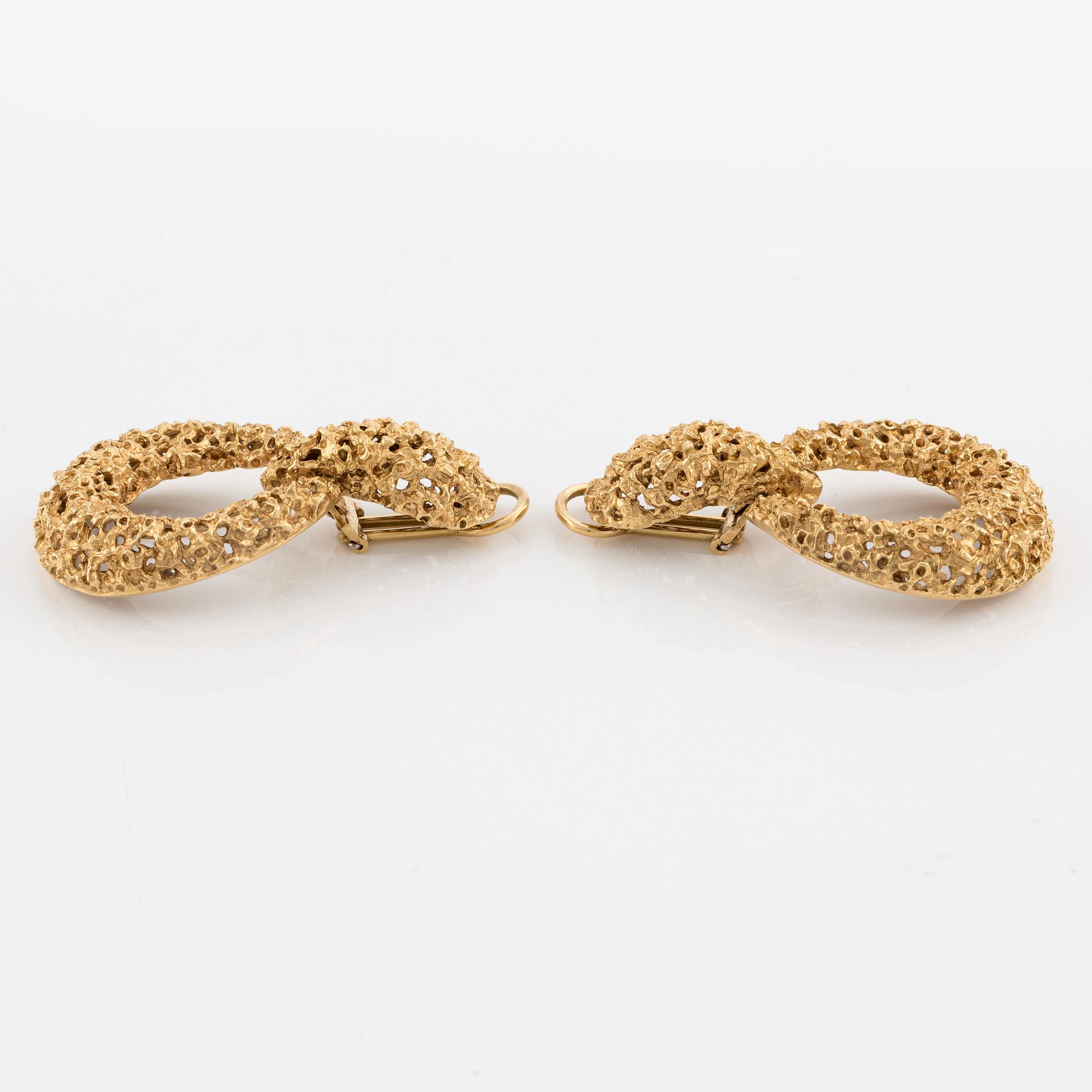A pair of 18K gold earrings.