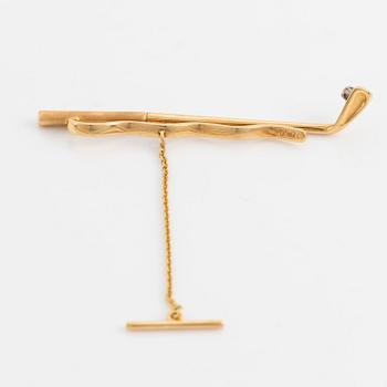 Slipsnål, 18K guld med briljantslipad diamant, i form av en golfklubba.