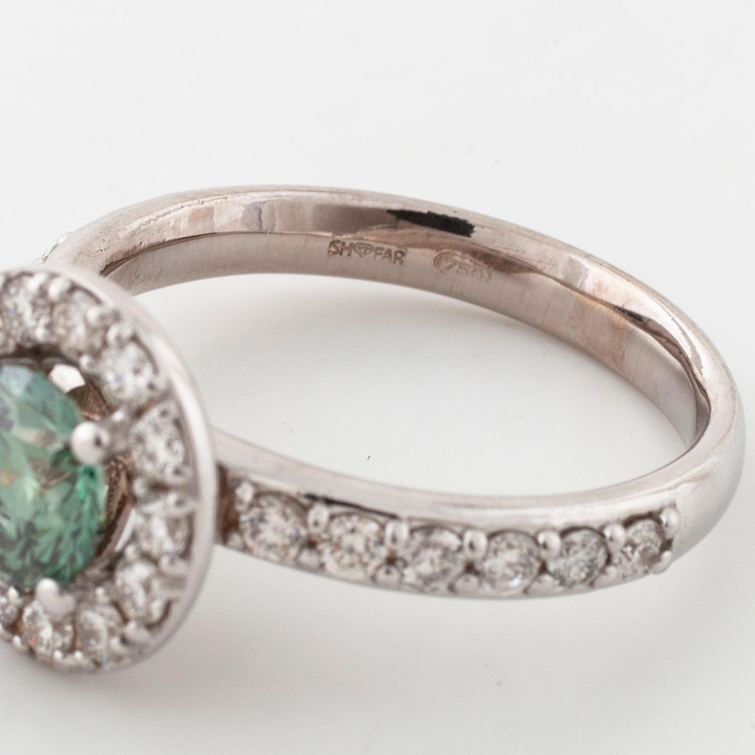 A treated green diamond and briliant cut diamonds.