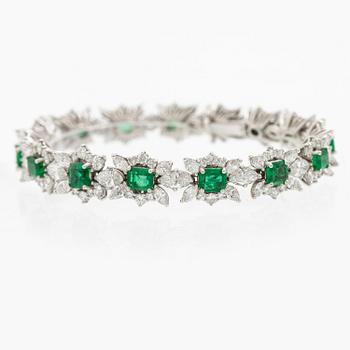 A bracelet in 18K white gold with step-cut emeralds and round and navette-shaped brilliant-cut diamonds.