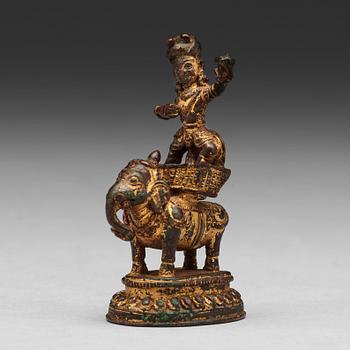 501. A gilt bronze figure of a deity on an elephant, presumably Nepal, 15th Century.