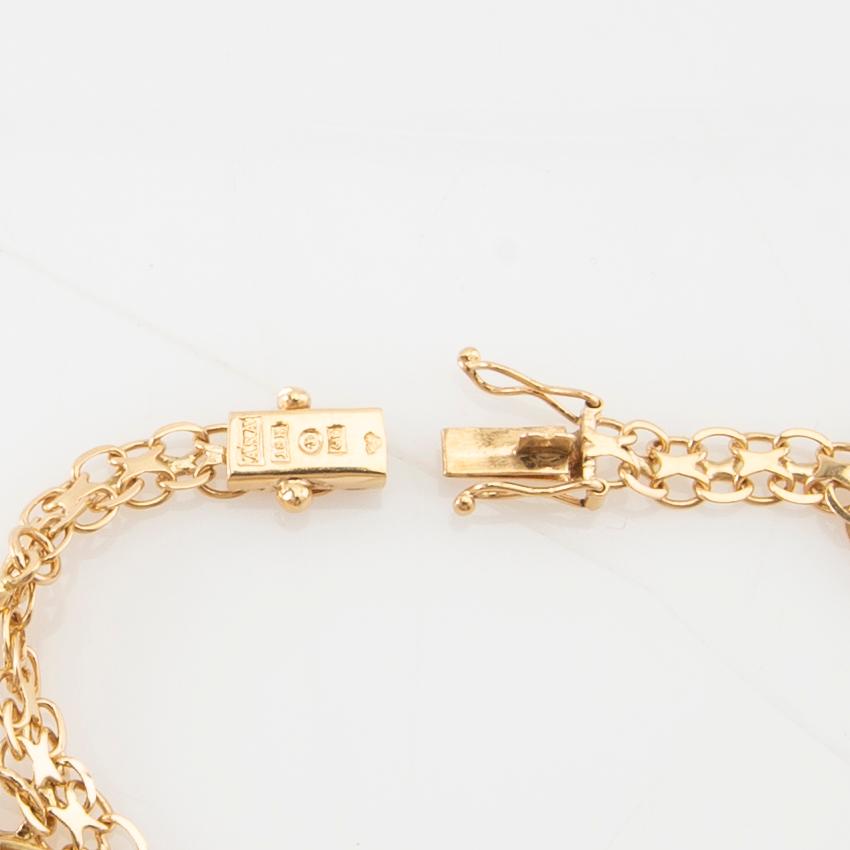 Bracelet 18K gold Bismarck link with charms.