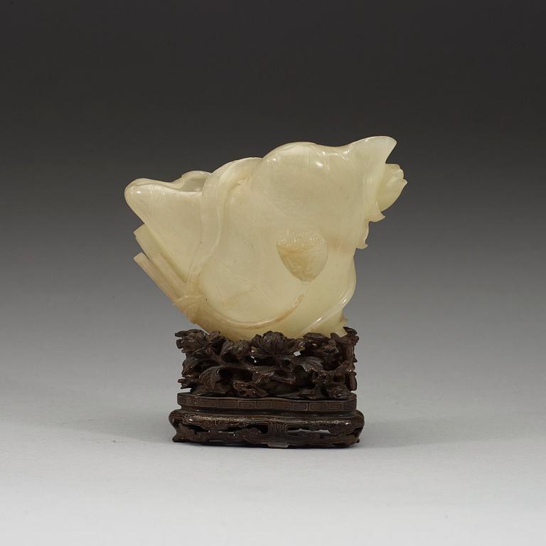 A nephrite brush washer, on a hardwood stand with silver inlay, Qing dynasty (1644-1912).