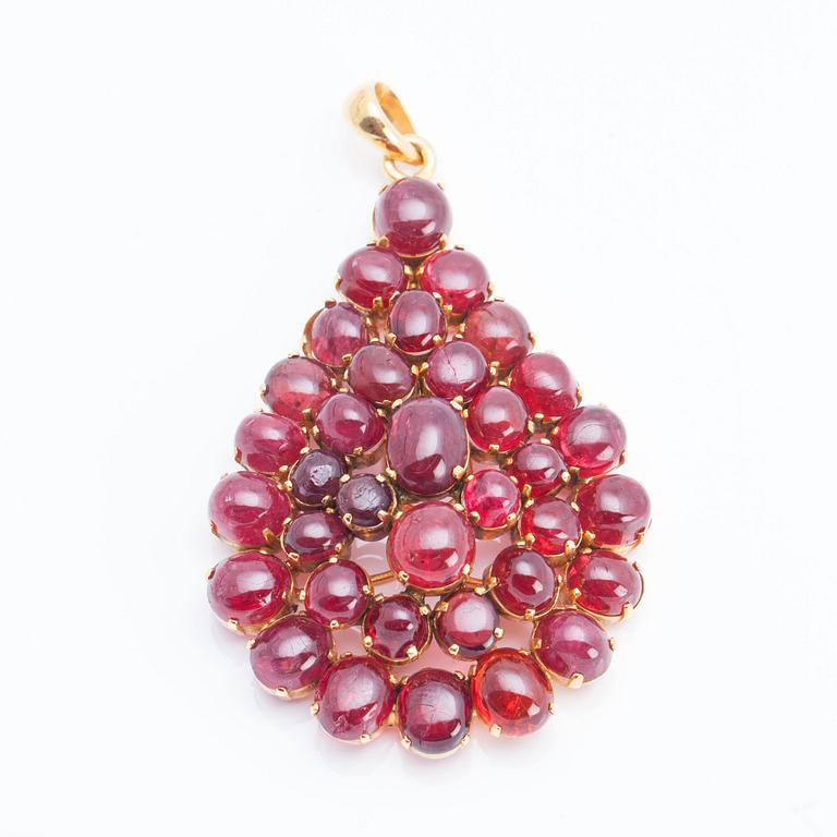 A cabochon-cut ruby pendant.